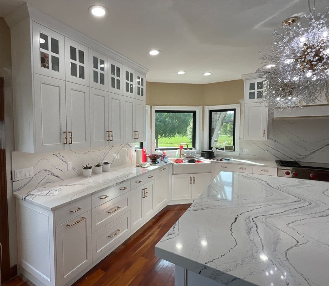 Kitchen island with wood cabinetry and pendant lighting